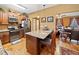 Open concept kitchen with a breakfast bar that connects to the living room and hardwood floors at 138 Rutledge Rd, Temple, GA 30179