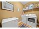 Practical laundry room with modern washer, dryer, and ample storage space at 138 Rutledge Rd, Temple, GA 30179