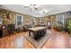 Large living room with a pool table, custom decor, and hardwood flooring at 138 Rutledge Rd, Temple, GA 30179