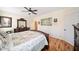 Main bedroom features a large wooden bed frame and furnishings, hardwood floors, and natural lighting at 138 Rutledge Rd, Temple, GA 30179
