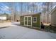 Exterior view of a shed with white trim and double doors next to a concrete pad at 138 Rutledge Rd, Temple, GA 30179