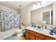 Well-lit bathroom featuring a vanity with dark cabinetry and a shower with a patterned curtain at 2145 Red Barn Ct, Cumming, GA 30040