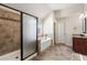Modern bathroom featuring tiled shower, soaking tub, and granite-topped vanity with a decorative mirror at 2145 Red Barn Ct, Cumming, GA 30040