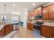 Open kitchen with stainless steel appliances, granite counters, and hardwood floors at 2145 Red Barn Ct, Cumming, GA 30040