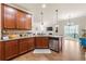 Open-concept kitchen with hardwood floors, granite counters, and stainless steel appliances at 2145 Red Barn Ct, Cumming, GA 30040