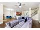 Open concept living area with hardwood flooring, fireplace, and a view of the kitchen at 2145 Red Barn Ct, Cumming, GA 30040