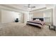 Large main bedroom featuring a sitting area, tray ceilings, and lots of natural light at 2145 Red Barn Ct, Cumming, GA 30040