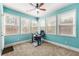 Bright home office with five windows, neutral carpet, and light teal walls at 2145 Red Barn Ct, Cumming, GA 30040