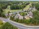 Aerial view of homes surrounded by mature trees and located near a golf course community at 3124 Bentgrass Ln, Kennesaw, GA 30144