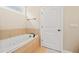 A clean bathroom includes a soaking tub with tiled surround and a tiled floor at 3124 Bentgrass Ln, Kennesaw, GA 30144