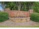 The Enclave community entrance is marked by a brick and stone monument sign with mature landscaping at 3124 Bentgrass Ln, Kennesaw, GA 30144