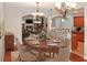 Formal dining room with large table set for eight, with adjacent living room and kitchen at 3124 Bentgrass Ln, Kennesaw, GA 30144