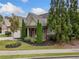 Attractive home with a covered porch, stone accents, and mature landscaping at 3124 Bentgrass Ln, Kennesaw, GA 30144