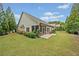 Exterior view of the home highlighting the screened in porch, manicured lawn and mature trees at 3124 Bentgrass Ln, Kennesaw, GA 30144
