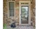 Charming entry way with brick and stone, a secure screen door, and black statuettes at 3124 Bentgrass Ln, Kennesaw, GA 30144