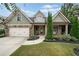 Charming home featuring stone and shingle accents, manicured lawn and an attached two car garage at 3124 Bentgrass Ln, Kennesaw, GA 30144