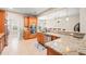 Open kitchen with granite countertops, stainless steel appliances, and wood cabinets at 3124 Bentgrass Ln, Kennesaw, GA 30144