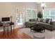 Relaxing living room with a comfortable sofa, desk, and a door to the patio at 3124 Bentgrass Ln, Kennesaw, GA 30144