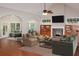 Cozy living room with a fireplace, built-in shelves, and neutral furniture at 3124 Bentgrass Ln, Kennesaw, GA 30144