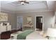 The bright main bedroom boasts a tray ceiling, hardwood floors and ensuite access at 3124 Bentgrass Ln, Kennesaw, GA 30144