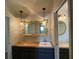 This vanity includes storage, a wood countertop, an interesting mirror, and decorative lighting at 445 Royal Oaks Ter, Stone Mountain, GA 30087