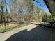This beautiful deck has a railing with a built-in bench overlooking the backyard at 445 Royal Oaks Ter, Stone Mountain, GA 30087