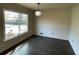 Bright dining room with a large window offering neighborhood views and dark, gleaming hardwood floors at 445 Royal Oaks Ter, Stone Mountain, GA 30087