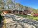 Charming brick home featuring a long driveway and a convenient covered carport area at 445 Royal Oaks Ter, Stone Mountain, GA 30087