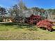 Well-kept brick home boasts mature trees and a spacious yard, adding to its curb appeal at 445 Royal Oaks Ter, Stone Mountain, GA 30087