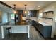 A modern kitchen featuring stainless steel appliances, a center island and gray cabinets at 445 Royal Oaks Ter, Stone Mountain, GA 30087