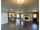 Open floor plan featuring a living room with fireplace, dark wood floors, and kitchen at 445 Royal Oaks Ter, Stone Mountain, GA 30087