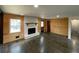 Cozy living room with wood paneling, a brick fireplace, and dark hardwood floors, perfect for relaxing at 445 Royal Oaks Ter, Stone Mountain, GA 30087