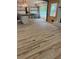 Spacious living room with hardwood floors, fireplace, and view to the kitchen with island at 445 Royal Oaks Ter, Stone Mountain, GA 30087