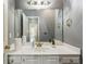 Bathroom with white vanity, large mirror, and neutral wall color at 5163 Holly Springs Dr, Douglasville, GA 30135