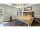 Comfortable bedroom with hardwood floors, a large window, and a rustic headboard at 5163 Holly Springs Dr, Douglasville, GA 30135