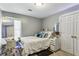 Bedroom with a large mirror, white bedding, and stylish decor at 5163 Holly Springs Dr, Douglasville, GA 30135