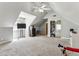 Bright bedroom featuring neutral walls, carpet floors, and a ceiling fan at 5163 Holly Springs Dr, Douglasville, GA 30135