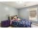 Bedroom with carpet, a queen bed with floral bedding, and a window with blinds at 5163 Holly Springs Dr, Douglasville, GA 30135