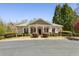 Charming community clubhouse featuring a welcoming entrance and well-manicured landscaping at 5163 Holly Springs Dr, Douglasville, GA 30135