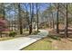 Long, paved driveway leading to a charming home surrounded by mature trees at 5163 Holly Springs Dr, Douglasville, GA 30135