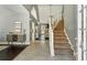 Spacious entryway with staircase, tile and hardwood floors, and stylish decor at 5163 Holly Springs Dr, Douglasville, GA 30135
