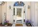 Close up of a beautiful front door with glass detailing, sidelights, and a welcoming mat at 5163 Holly Springs Dr, Douglasville, GA 30135