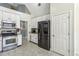 Bright kitchen features stainless steel appliances, tile flooring, and white cabinets at 5163 Holly Springs Dr, Douglasville, GA 30135