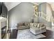 Living room featuring a fireplace, large sectional sofa, hardwood floors, and view of the staircase at 5163 Holly Springs Dr, Douglasville, GA 30135