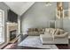 Bright living room with a fireplace, large sectional sofa, high ceilings, and hardwood floors at 5163 Holly Springs Dr, Douglasville, GA 30135