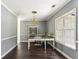 Well-lit home office featuring a large desk, chair, and ample natural light from the large window at 5163 Holly Springs Dr, Douglasville, GA 30135
