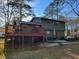 Back of home featuring a large deck and covered patio at 198 Lexington Ct, Riverdale, GA 30274