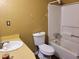Bathroom with white fixtures and a shower-tub combo at 198 Lexington Ct, Riverdale, GA 30274