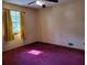 Bedroom with magenta carpet and views of the front yard at 198 Lexington Ct, Riverdale, GA 30274
