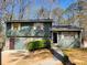 Split-level home with painted siding, stone accents, and attached garage at 198 Lexington Ct, Riverdale, GA 30274